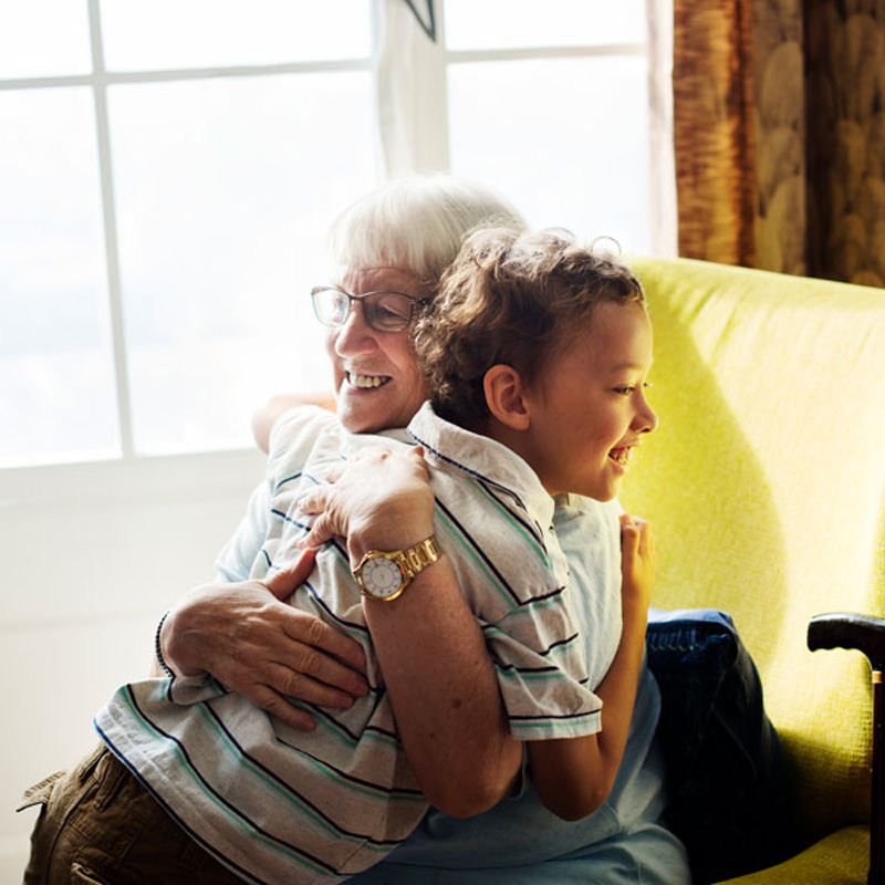 elderly woman hugging child